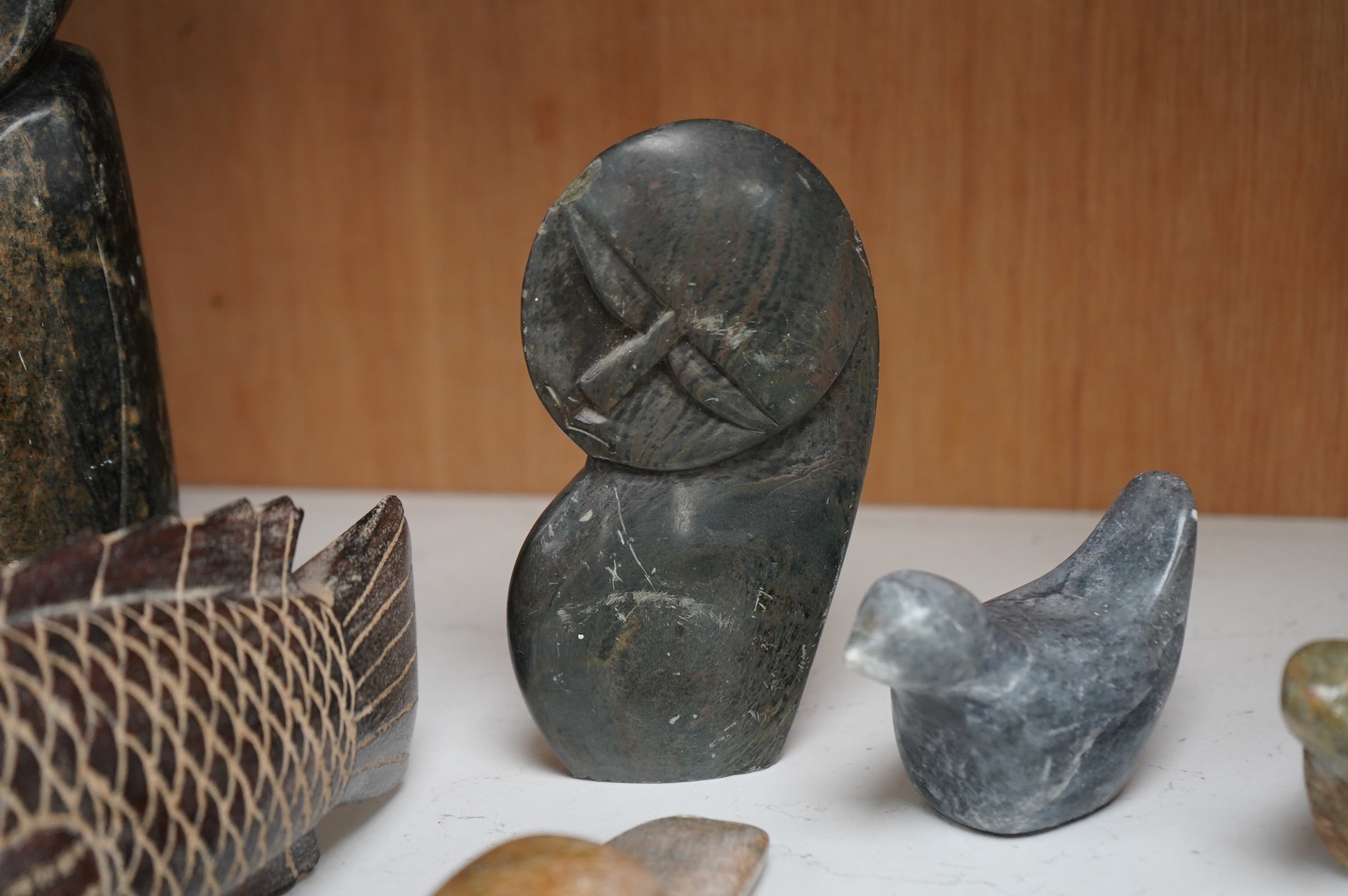 Eleven Inuit related stone carvings, unsigned, to include birds and abstract figures, largest 22cm high